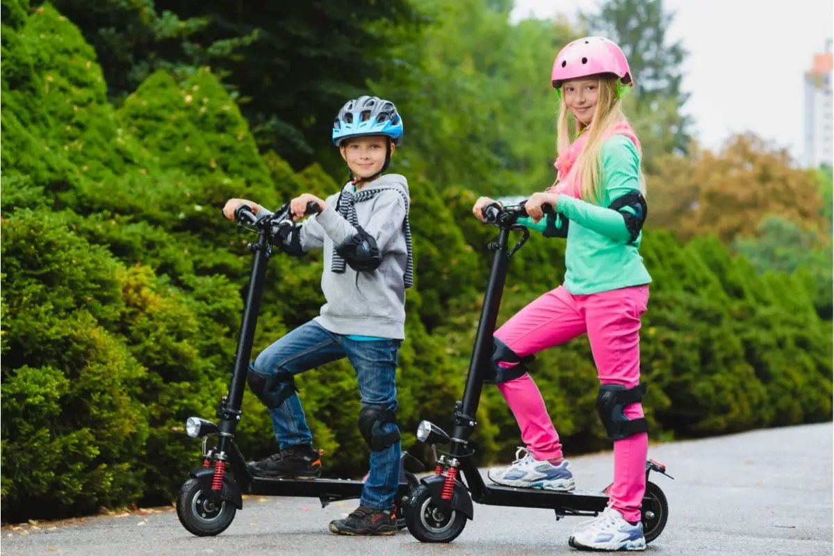 Buyers Guide    Safety Gear   It's imperative to ensure your child's safety when they are going to be using an electric scooter. At the very least, provide them with a high-quality helmet to protect them from any nasty bumps to the head.   You might also want to level up their protection and encourage them to use elbow and knee pads, as tacking a whack on these can be painful indeed! Gloves can help prevent any unfortunate scrapes and cuts, whilst reinforced wrist guards greatly help in preventing strains or worse!   Let’s also consider what time of day your child might be using the electric scooter, and where will they be traveling? If they are likely to encounter other riders, pedestrians, or vehicles whilst they travel, then be sure to add a bell (or horn?) to your child's scooter. The easier it is for them to alert those around them, the better.   If your child will be using the electric scooter during hours when the light is fading and the night emerges, then they will need extra protection. The best way to combat the darkness is with visibility, which can be achieved through various means.   Some methods include wearing reflective clothing, wearing reflective straps on the wrists or ankles, and adding reflective stickers to your child's bag and scooter. You could add a light to the scooter or your child's bag, whilst some parents have had their children wearing head torches for optimum vision and visibility!   Highway Code & The Rules Of The Road  Always carefully check local laws and regulations regarding electric scooters and their use, as these vary from state to state and locality to locality. Be sure to use the scooter in an appropriate location, especially whilst your child is still getting to grips with learning how to ride.   Teaching children about the Highway Code and the ‘Rules of the Road’ can be both fun and educational.  Encourage them to learn how to stay safe when walking or riding, how to interact with others, and how to navigate the road and sidewalks safely.    Teach them about when it's appropriate to stop, safe to go, and how to indicate which direction they want to turn. The most simple way is using hand signals, though, of course, scooters are safer when ridden with two hands!  To help them turn safely, encourage your child to slow down before using a hand signal, and be patient before making their turn.   Are You Ready To Ride?  Before you let your child drive off into the sunset like an easy rider, make certain that both your child and the scooter are ready!   Carefully and patiently explain and demonstrate how the different aspects of the scooter work. Show them proper form and technique for riding, ensure they understand the braking system and that they can carefully control the scooter's acceleration.   Carefully check that the scooter is in optimal condition, check that there are no loose bits and bobs, nuts, bolts, or wires that seem out of place. Check the handlebars are sturdy and the wheels are firmly connected. Allow the battery a full charge before testing out the electrics, ensuring both the throttle and brake work efficiently. Once you’re satisfied that both your child and the scooter are ready, then it’s time for some fun!   Factors To Consider Before Buying  Growing Pains  Is your child at that stage where they’re growing at a seemingly exponential rate? If so, carefully consider whether the scooter you’re looking at is futureproof. Much like clothes, shoes, and bicycles, kids could grow out of an electric scooter pretty fast. They might become too large to comfortably use it, or feel underwhelmed by the reduced power as they grow older and seek a more thrilling experience.  How Far Will They Travel?  Consider where and how far your kid might be traveling on the scooter. If they only intend to play in your neighborhood, then range and battery life aren't so important. However, if your child intends to ride it to school, to a family or friend’s place, then more careful consideration is needed. Battery life, range, and charging time become especially critical in these circumstances, so be sure to pick a suitable scooter for your kid’s needs.   How Old Is Your Kid?  Most scooters are designed with a specific or minimum age requirement, though of course, these cannot account for differing sizes of children and levels of ability. Ensure that your child is suitably confident and skilled enough before they step up to a more powerful electric scooter. If they suddenly go from a maximum speed of 7.5 mph to one of 15 mph, it could be easy for them to feel nervous and lack control.   Where's The Trunk?  If your child is carrying school bags or other baggage, be sure to account for that additional weight when considering your purchase. Scooters with a bigger deck or seating will provide a more comfortable and safer riding experience when carrying any cargo. 
