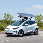 charging electric car with solar panels on roof